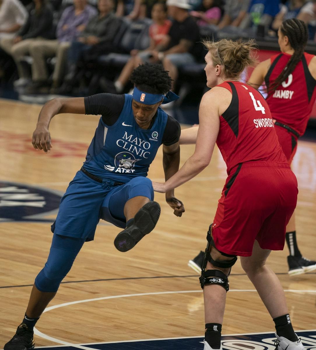 Las Vegas Aces center Carolyn Swords (4) was called for a first half foul while defending Minnesota Lynx center Sylvia Fowles (34) in the first half.