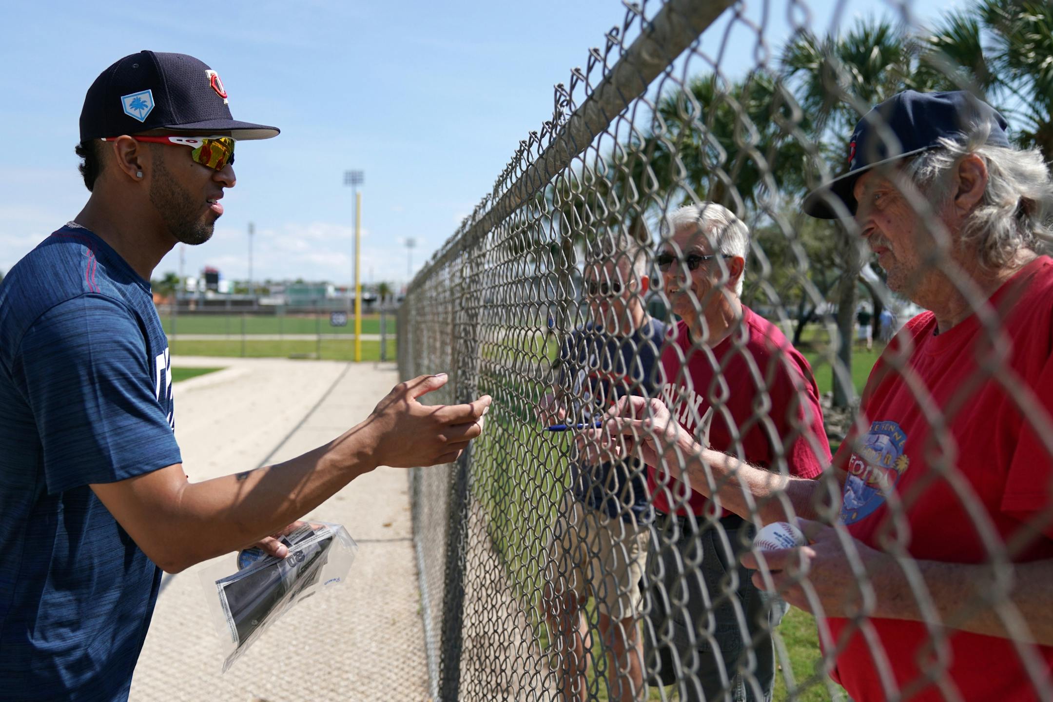 Minnesota Twins left fielder Eddie Rosario (20) signed an autograph for a fan after informal drills Saturday.