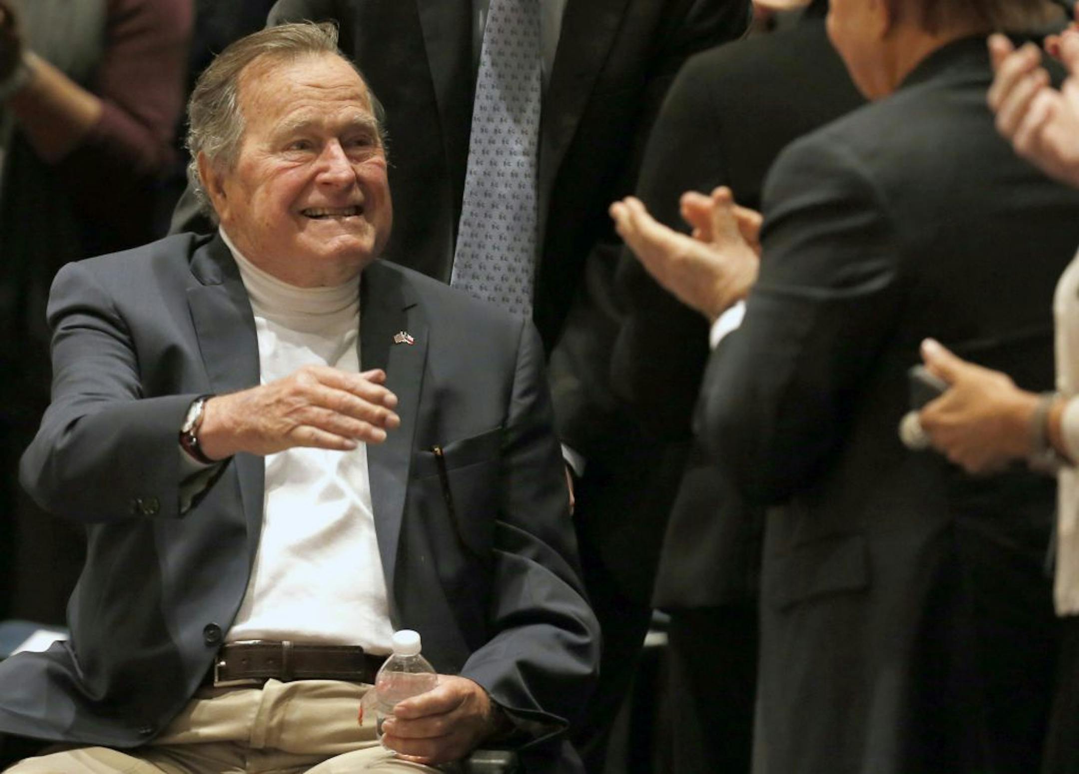 FILE - In this Nov. 11, 2014, file photo, former President George H.W. Bush acknowledges the crowd at his presidential library in College Station, Texas. Houston-area media are quoting former President George H.W. Bush's chief of staff as saying that Bush has been hospitalized in Houston.