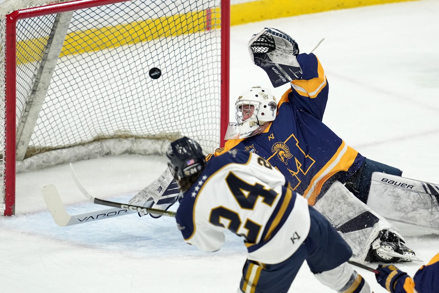 Hermantown forward Dallas Vieau (24) scores past Mahtomedi goaltender Charles Brandt (30) in the first period of a MSHSL Class 1A state semifinal hockey game between Hermantown and Mahtomedi Friday, March 10, 2023 at the Xcel Energy Center in St. Paul, Minn. ] ANTHONY SOUFFLE • anthony.souffle@startribune.com