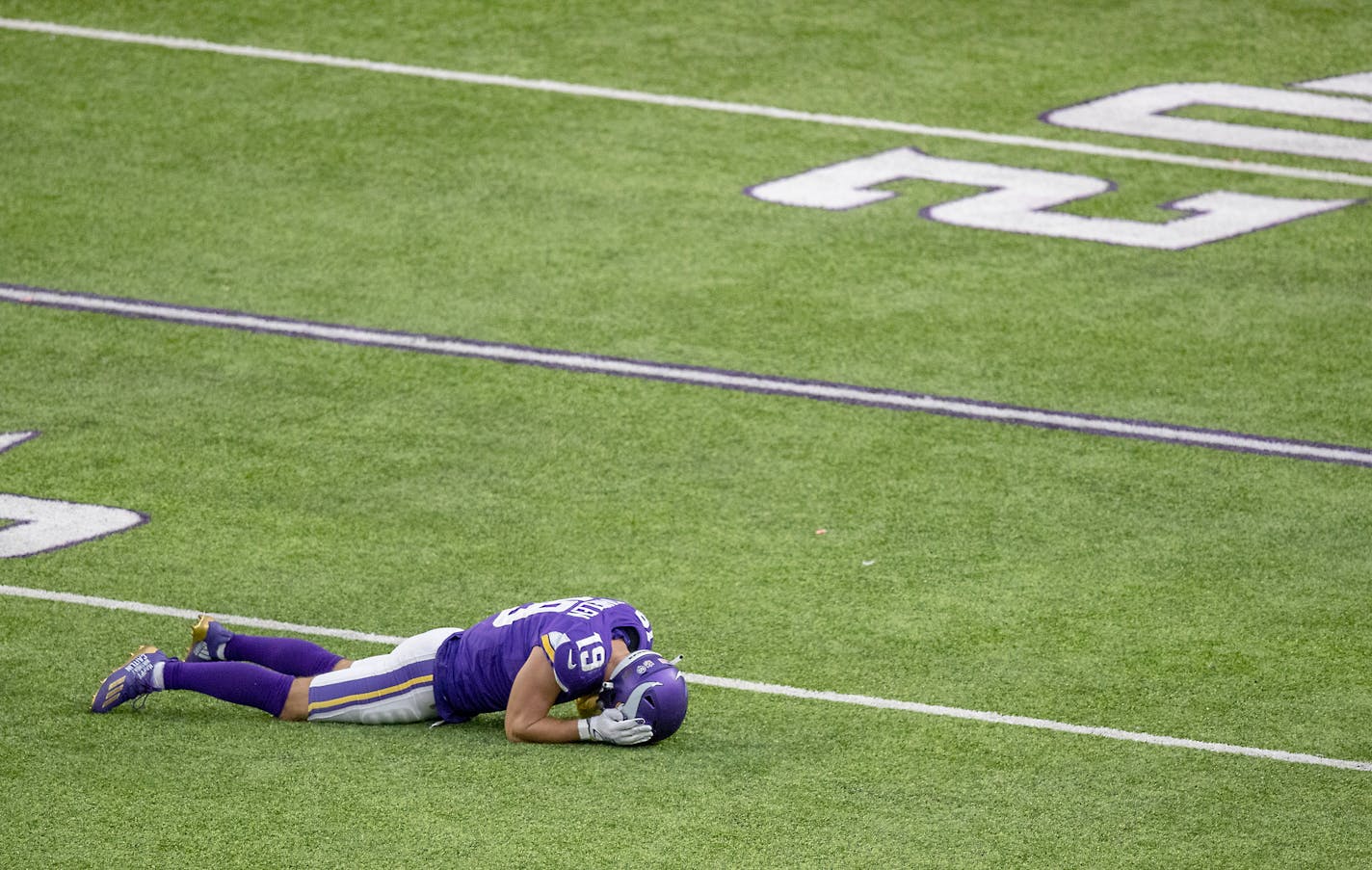 Adam Thielen laid dejected on the field after a Kirk Cousins pass was intercepted by Tennessee earlier this season.