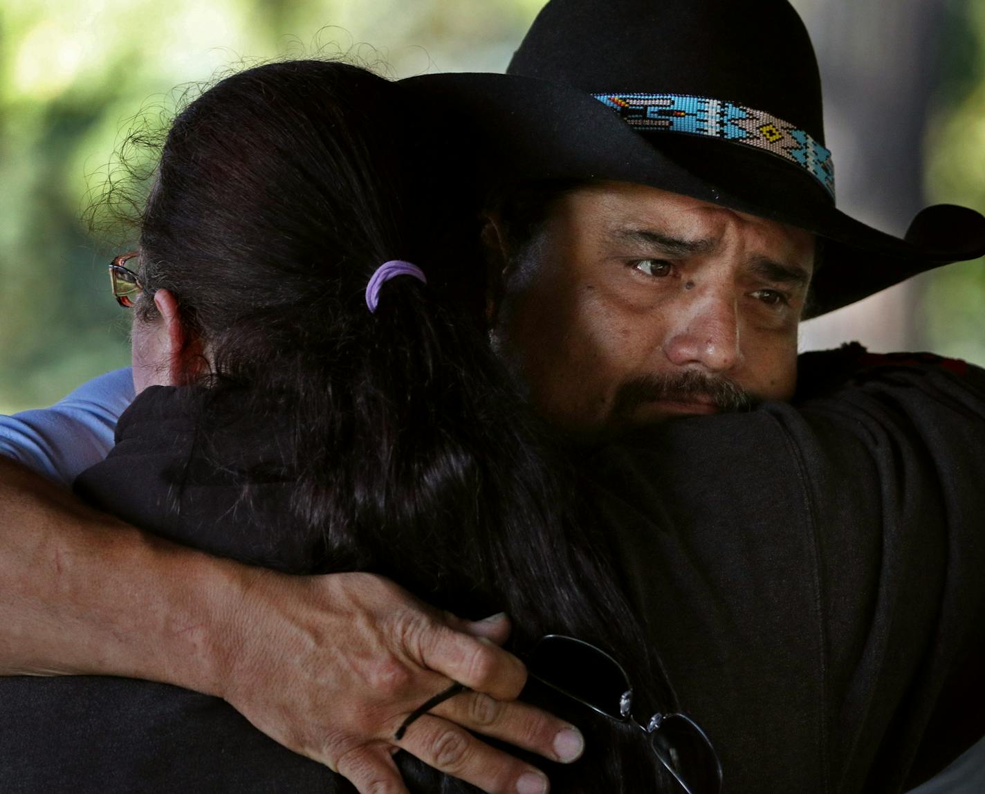 Joe Greywind, the father of missing 22-year-old Savanna Greywind, got a hug from volunteer search coordinator Christina Becker as they gathered to help organize the efforts to find Greywind on Sunday morning at Trollwood Park in Fargo.