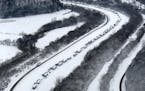 Cars and trucks are stranded Thursday, March 5, 2015, along Interstate 65 in Hardin and Bullitt counties in Kentucky due to a heavy accumulation of sn