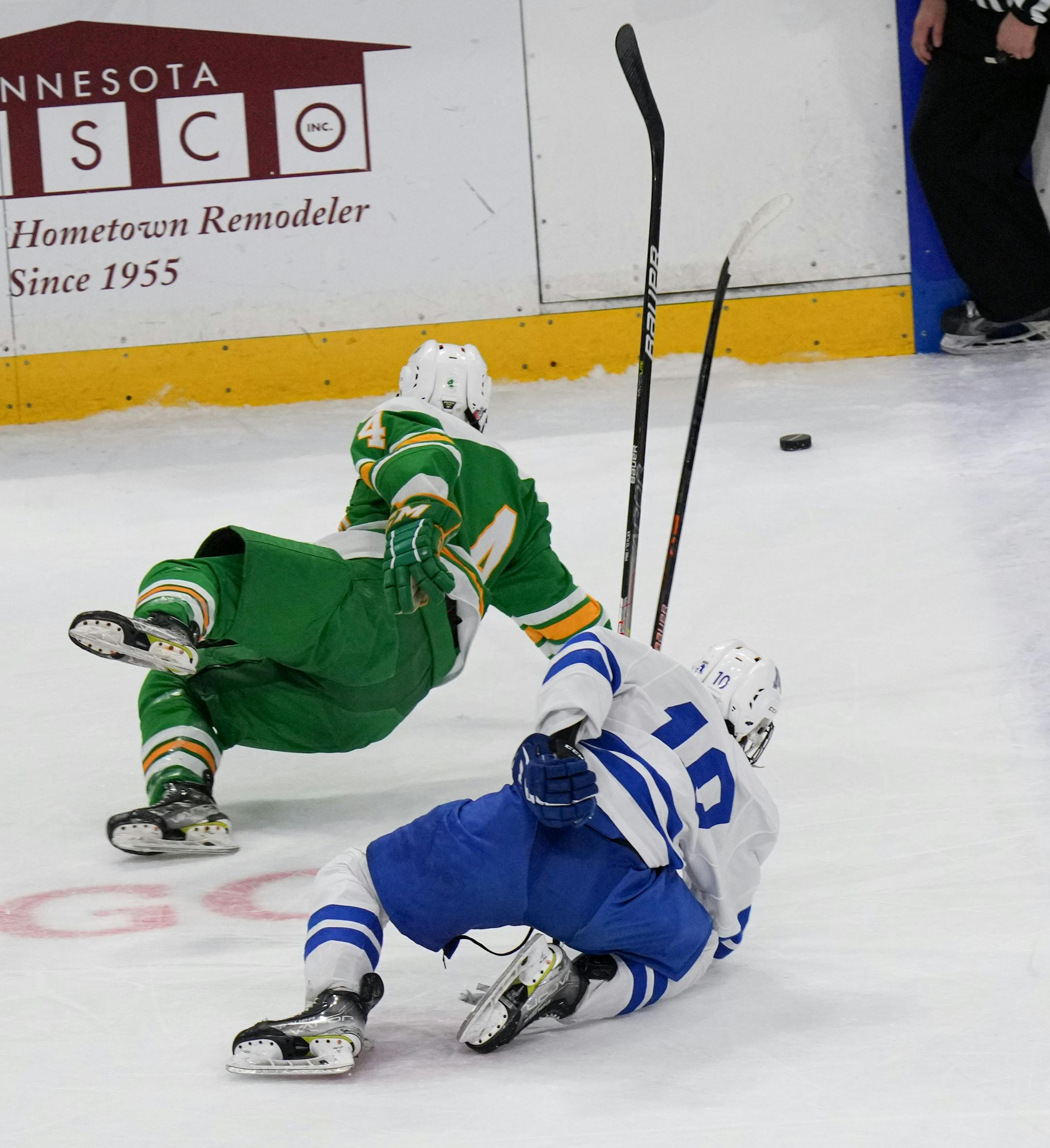Edina defenseman Barrett Dexheimer (4) and Minnetonka forward Luke Garry (10) went down chasing the puck in the second period as Edina.
