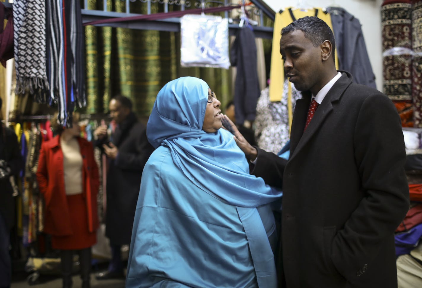 Minneapolis City Council member Abdi Warsame spoke with shopkeeper Fadumo Mohamed while he led Mayor Betsy Hodges, rear, on a swing through the Village Market Thursday afternoon. ] JEFF WHEELER &#xef; jeff.wheeler@startribune.com Minneapolis City Council member Abdi Warsame is making it his mission to take on the Sabri family of landlords that own the two Somali malls in Minneapolis. Tenants complain about conditions in the Village Market on 24th St. but fear reprisals if they bring their concer