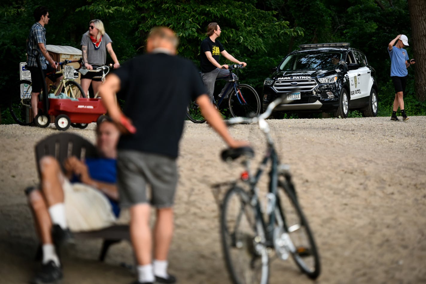 A Minneapolis Park Patrol officer watched over the scene from his vehicle at Cedar Beach Wednesday evening. ] AARON LAVINSKY • aaron.lavinsky@startribune.com They all add up to make the so-called Hidden Beach at Cedar Lake the top spot for problem calls to the Minneapolis Park Board police. The problems are so bad that the Kenwood-Isles neighborhood group kicked in $5,000 to cover police overtime hours. Safety at the East Cedar Beach is one of the neighborhood's top priorities. With temperatures