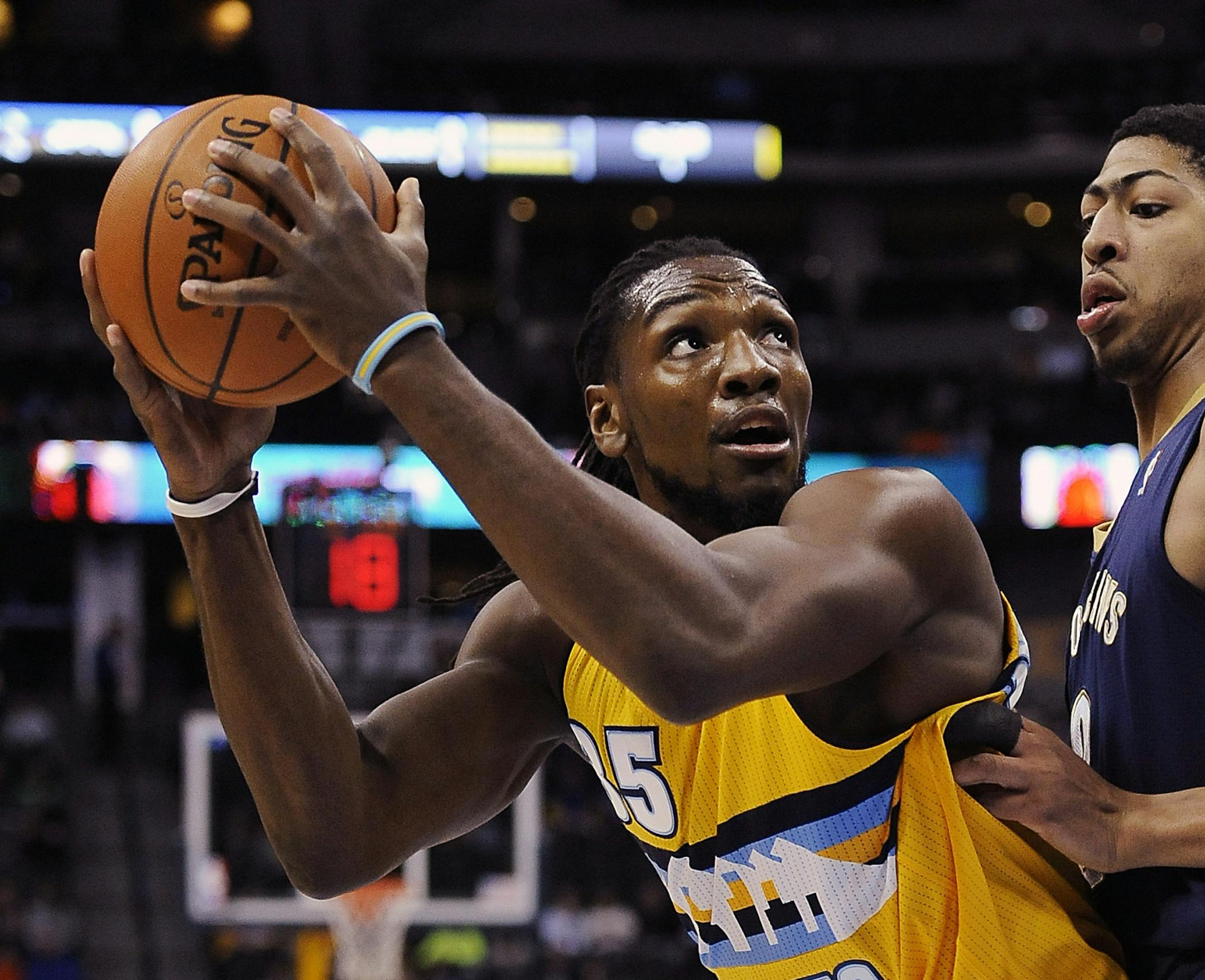 Denver Nuggets forward Kenneth Faried, left, looks to score over New Orleans Pelicans forward Anthony Davis, right, in the first half of an NBA basketball game on Wednesday, April 2, 2014, in Denver. (AP Photo/Chris Schneider) ORG XMIT: COCS104