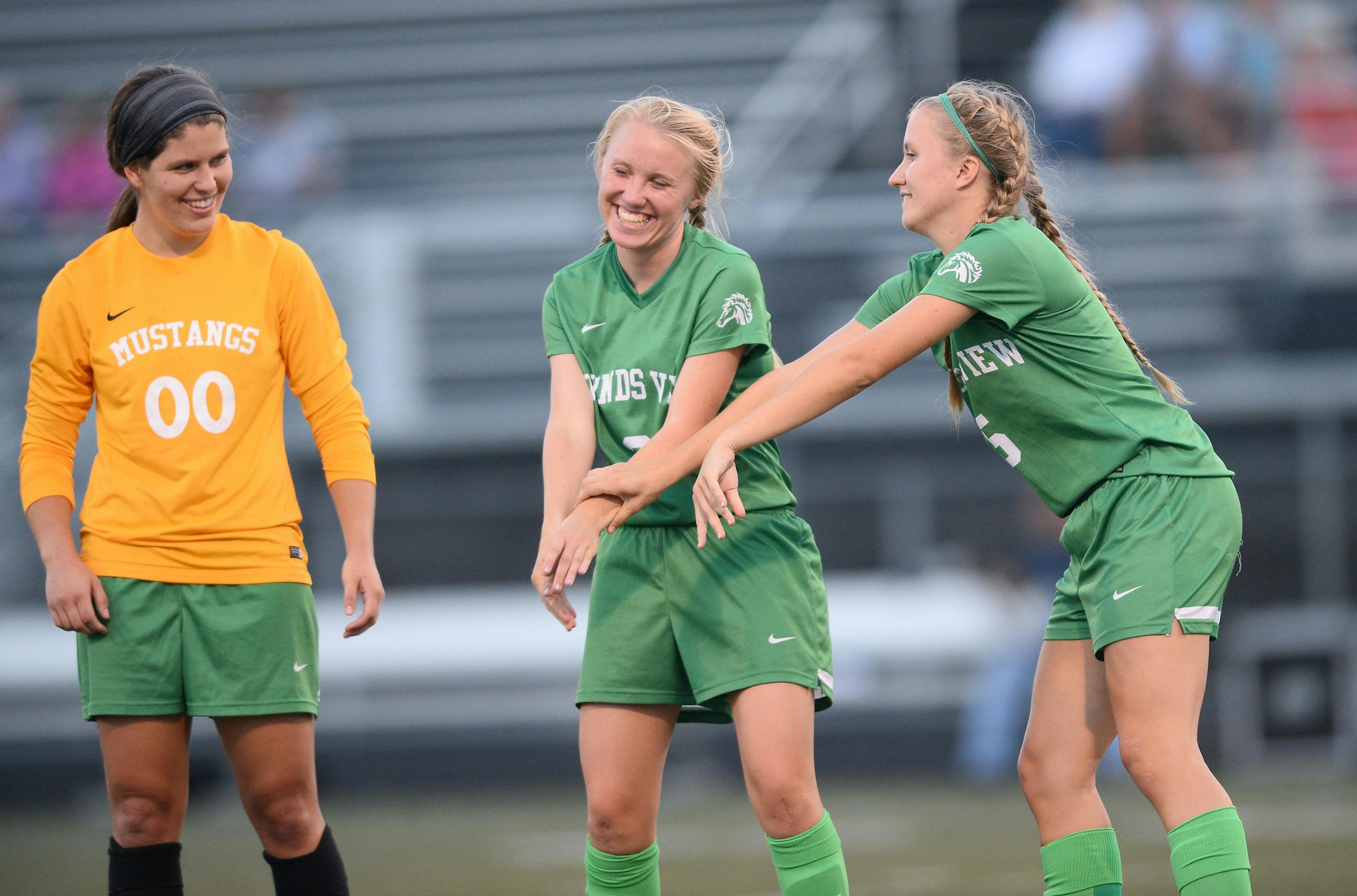Mounds View goalkeeper Olivia Elvidge watched as sisters Emily Boyer, center, and Rachel Boyer joked around during player introductions Tuesday night. ] Aaron Lavinsky • aaron.lavinsky@startribune.com North zone feature on Mounds View girls' soccer. We photograph the Mounds View Mustangs play the Burnsville Blaze at Burnsville on Tuesday, Sept. 1, 2015.