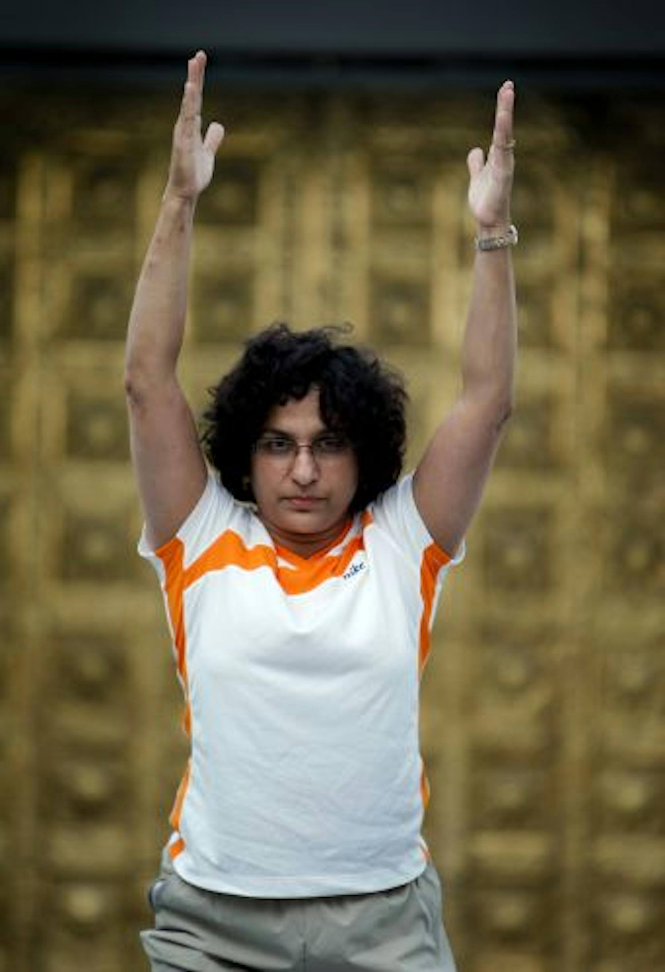 Mythili Chari, instructor at the Hindu Temple of Minnesota, teaches yoga as it was originally practiced — with prayer, meditation and in a striking temple setting.