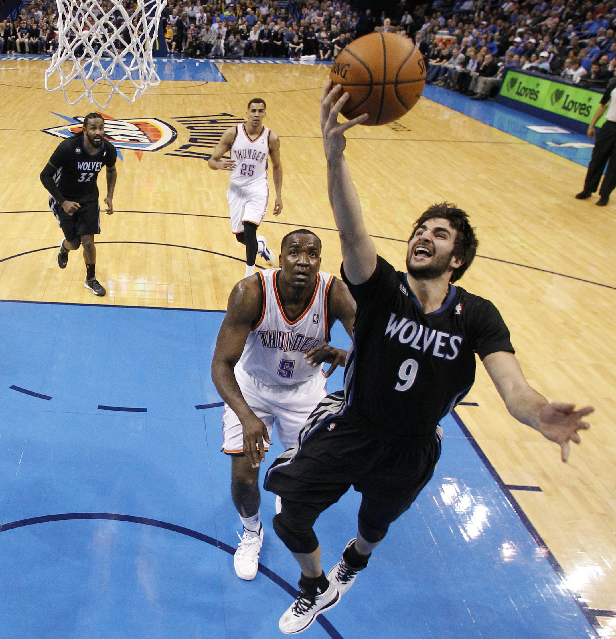 Minnesota Timberwolves guard Ricky Rubio (9) shoots in front of Oklahoma City Thunder center Kendrick Perkins (5) during the third quarter of an NBA basketball game in Oklahoma City, Wednesday, Feb. 5, 2014. Oklahoma City won 106-97. (AP Photo/Sue Ogrocki)