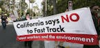 Los Angeles community members take to the streets of Beverly Hills to demand that Hillary Rodham Clinton oppose the Trans-Pacific Partnership (TPP) an