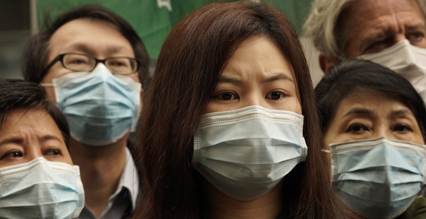 Medical staff strike over coronavirus concerns outside government headquarters in Hong Kong, Wednesday, Feb. 5, 2020. In Hong Kong, hospitals workers are striking to demand the border with mainland China be shut completely to ward off the virus, but four new cases without known travel to the mainland indicate the illness is spreading locally in the territory. (AP Photo/Vincent Yu)