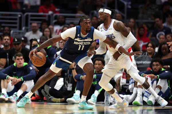 Wolves center Naz Reid drove on the Clippers’ Robert Covington in Sunday’s game in Los Angeles. Reid had 20 points and 11 rebounds, playing more p