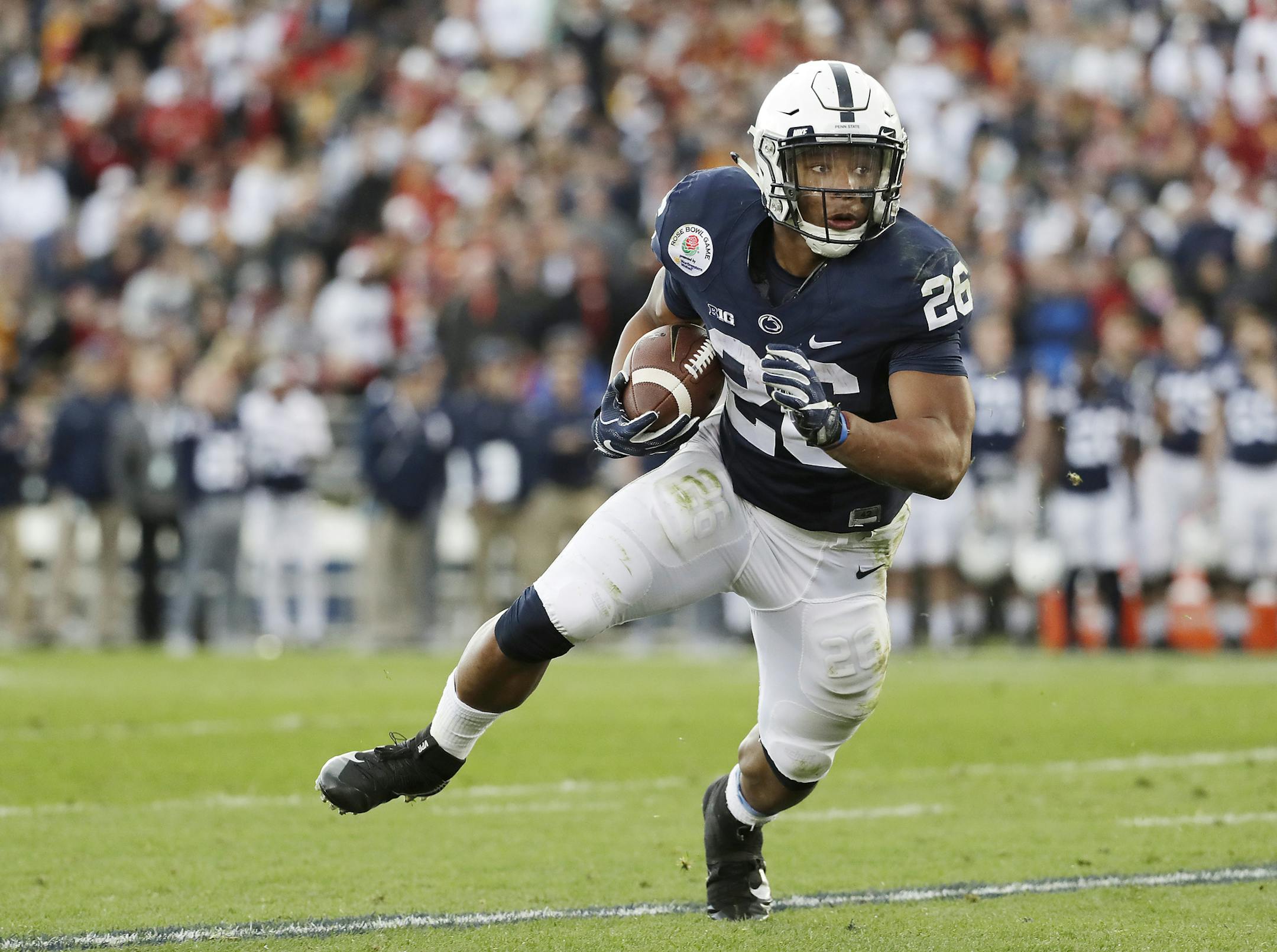 File-This Jan. 2, 2017, file photo shows Penn State Nittany Lions running back Saquon Barkley looking for room to run against USC during the first half of the Rose Bowl NCAA college football game, in Pasadena, Calif. Southern California quarterback Sam Darnold and Barkley put on a show at the Rose Bowl to end last season, and established themselves as two of the biggest stars in college football coming into 2017. Now the two Heisman Trophy contenders highlight The Associated Press preseason All-