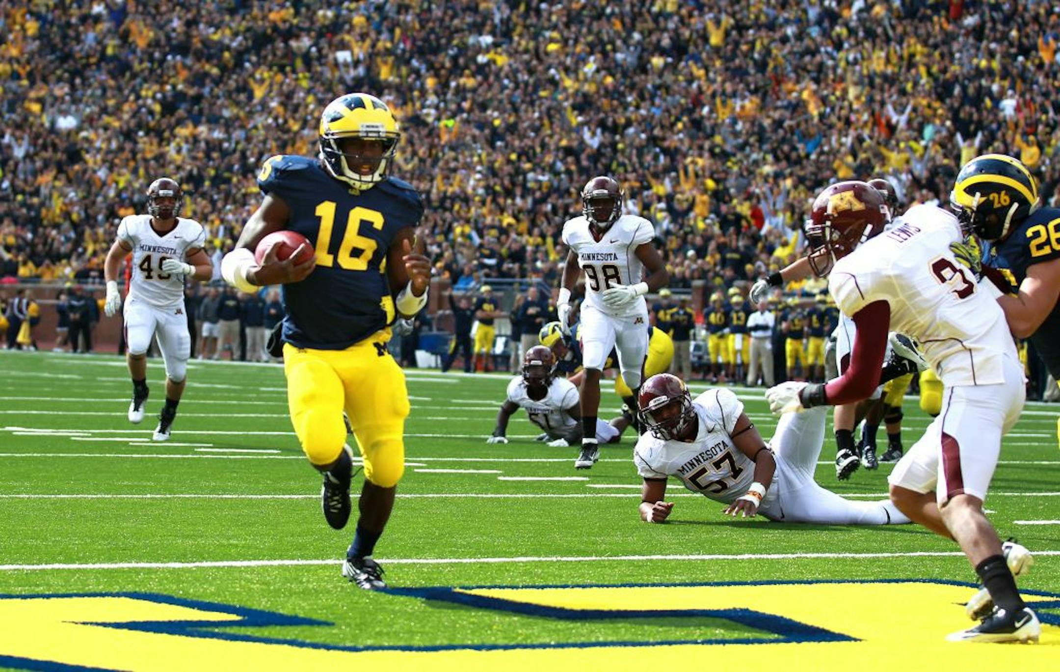 Michigan's quarterback Denard Robinson scored on a 9 -yard touchdown run in the first quarter of last year's blowout.