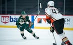 Minnesota Wild left wing Kirill Kaprizov (97) focused on Anaheim Ducks defenseman Josh Manson (42) as he brought the puck out in the first period. ] J