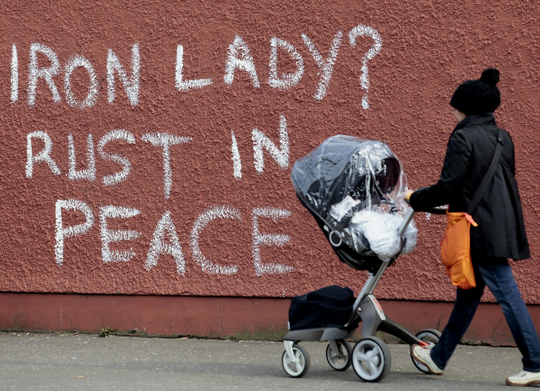 Anti-Margaret Thatcher graffiti adorns a wall on the Falls Road in west Belfast, Northern Ireland, Tuesday, April 9, 2013. The former prime minister died on Monday aged 87 after suffering a stroke while staying at the Ritz hotel in central London. Later on Monday, "street parties" were held in Londonderry and west Belfast as well as other parts of Britain. (AP Photo/Peter Morrison)