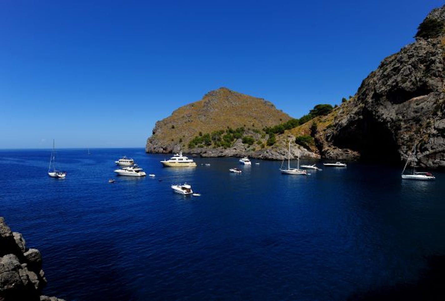 PALMA DE MALLORCA, SPAIN - AUGUST 15: Boats float on the blue waters of Cala de Calobra near Torrent de Pareis on August 15, 2009 in Palma de Mallorca, Spain.