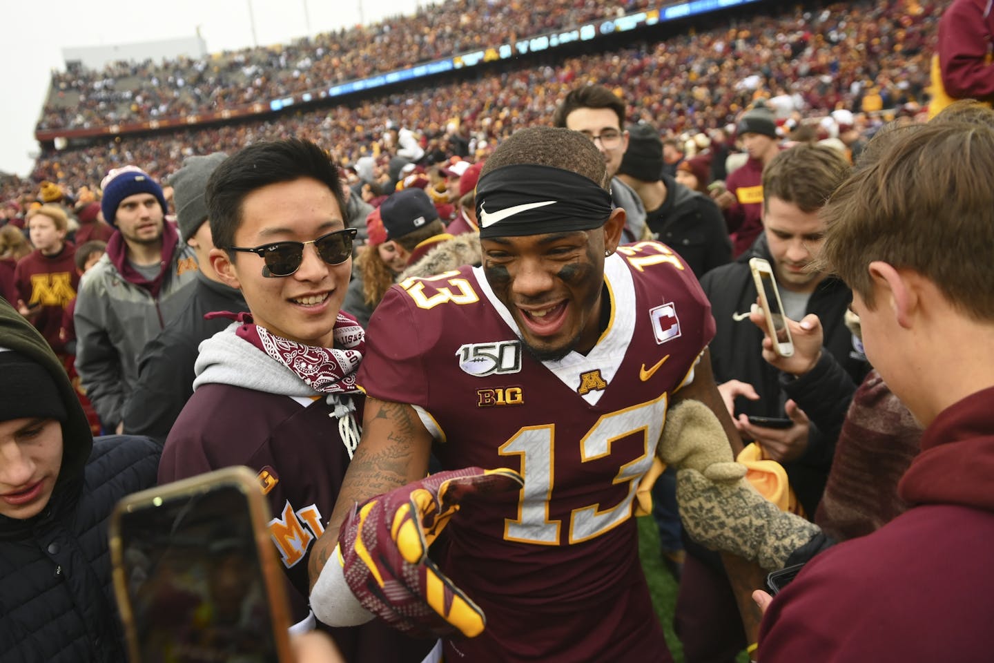 Gophers wide receiver Rashod Bateman (13), who caught seven passes for 203 yards and scored Minnesota's first touchdown, celebrated the victory with fans after the game.