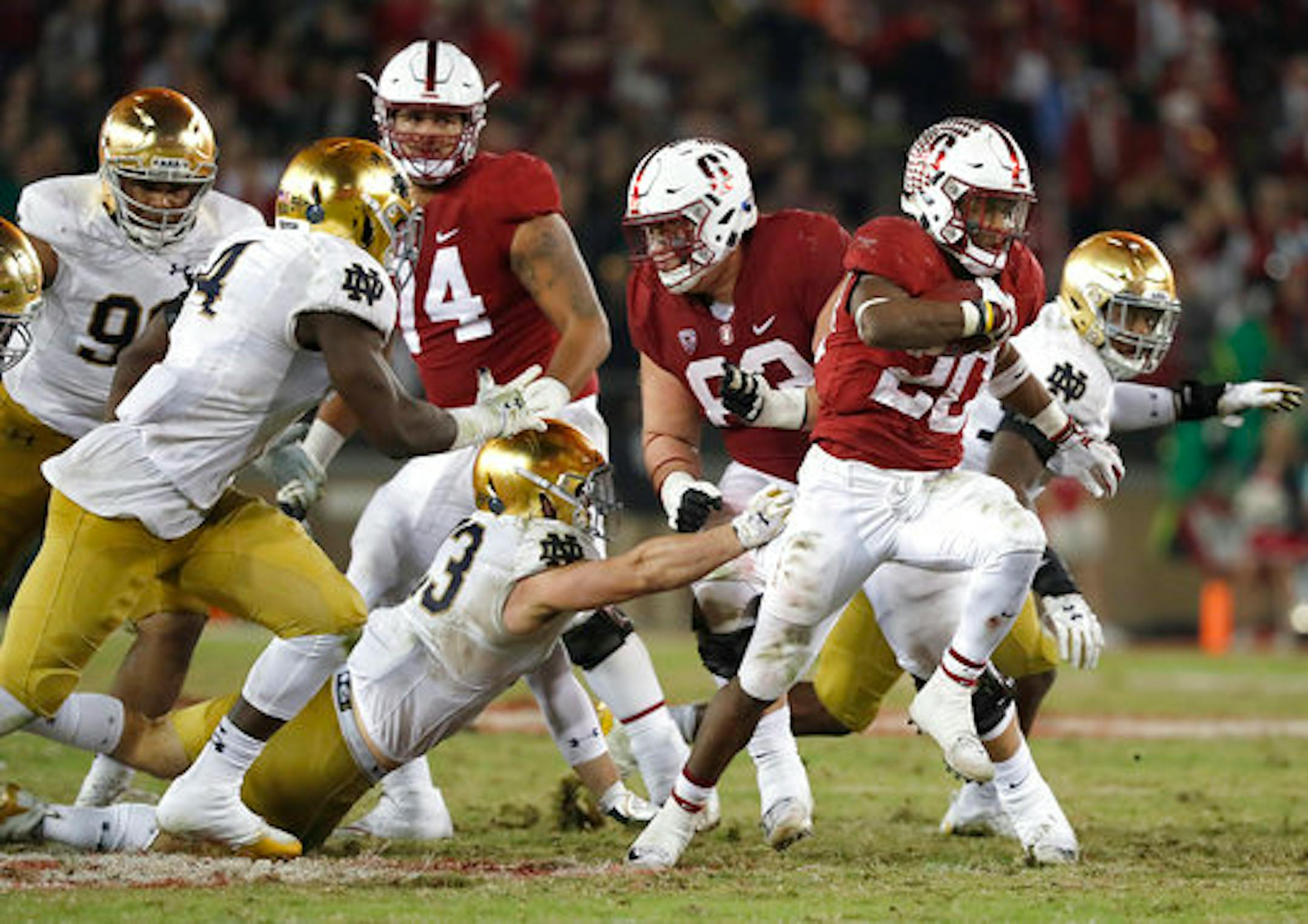 Stanford running back Bryce Love (20) breaks through the line for a first down against Notre Dame throws against Stanford during the second half of an NCAA college football game Saturday, Nov. 25, 2017, in Stanford, Calif. Stanford won 38-20. (AP Photo/Tony Avelar)