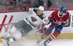Minnesota Wild's Nick Seeler (55) slides into the boards next to Montreal Canadiens' Joel Armia during third&#xb6; -period NHL hockey game action in M