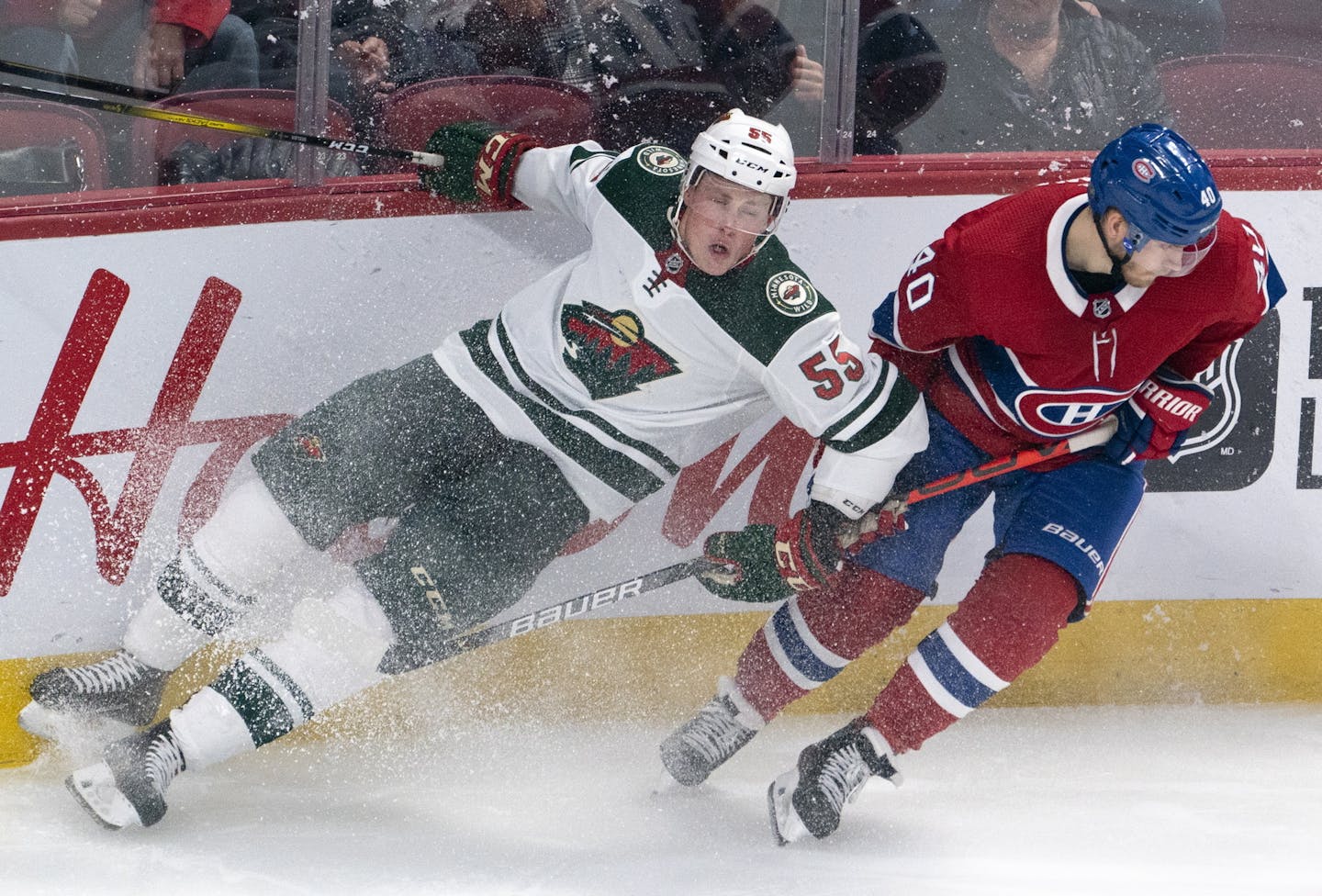 Minnesota Wild's Nick Seeler (55) slides into the boards next to Montreal Canadiens' Joel Armia during third&#xb6; -period NHL hockey game action in Montreal, Thursday, Oct. 17, 2019. (Paul Chiasson/The Canadian Press via AP)