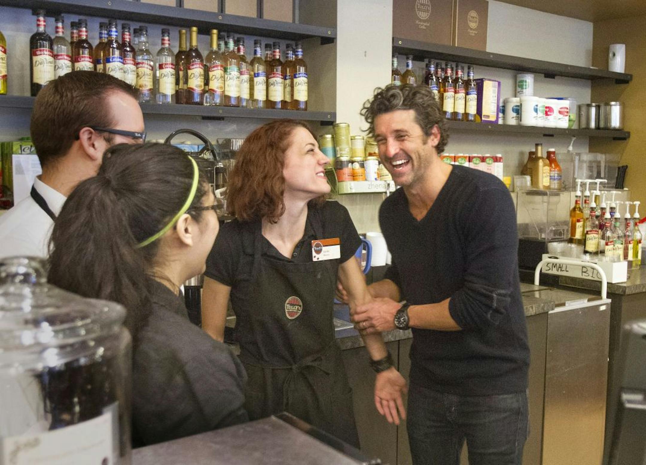Patrick Dempsey's investment group has won the bid to purchase Tully's Coffee. Dempsey meets the staff at the Tully's Coffee on Western Avenue near the Pike Place Market on Friday, Jan. 4, 2013. Dempsey meets with employees from left including Stephen Loewen, Susie Campos and Sarah Paulson. (AP Photo/The Seattle Times, Mike Siegel) OUTS: SEATTLE OUT, USA TODAY OUT, MAGAZINES OUT, TELEVISION OUT, SALES OUT. MANDATORY CREDIT TO: MIKE SIEGEL/THE SEATTLE TIMES.