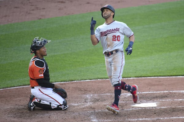 Minnesota Twins' Eddie Rosario (20) reacts after hitting a solo home run in the fifth inning of a baseball game against the Baltimore Orioles, Saturda