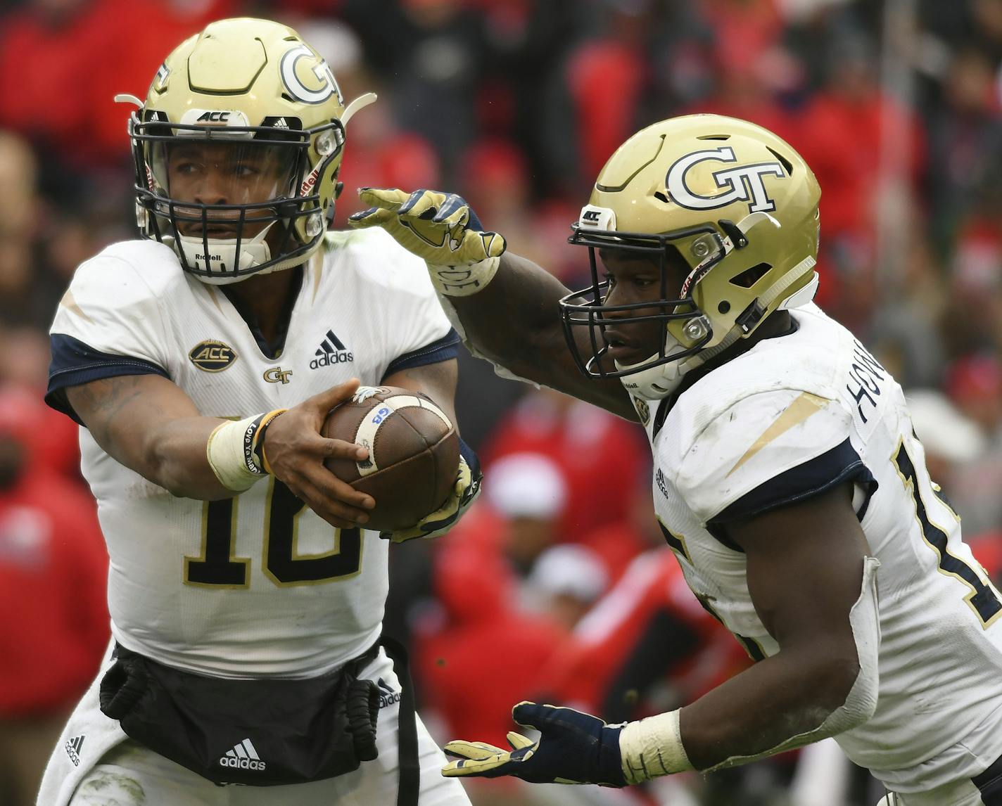 ATHENS, GA - NOVEMBER 24: Georgia Tech Yellow Jackets quarterback TaQuon Marshall (16) hands the ball off Georgia Tech Yellow Jackets running back Jerry Howard (15) during the game between the Georgia Tech Yellow Jackets and the Georgia Bulldogs on November 24, 2018, at Sanford Stadium in Athens, GA. (Photo by Jeffrey Vest/Icon Sportswire) (Icon Sportswire via AP Images) ORG XMIT: 312657