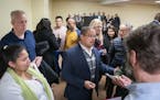 Keith Ellison is surrounded by people following the listening session last week.