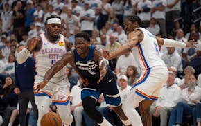 Timberwolves guard Anthony Edwards loses control of the ball while driving between Thunder guard Luguentz Dort, left, and Thunder forward Jalen Willia