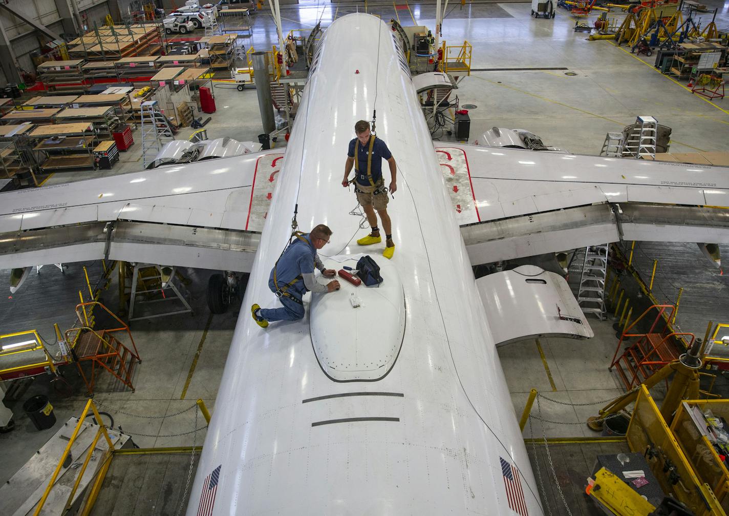 Kieran Cummings, right, a second-year Lake Superior College student, worked with AAR Corp. mechanic Bradley Gangstad.