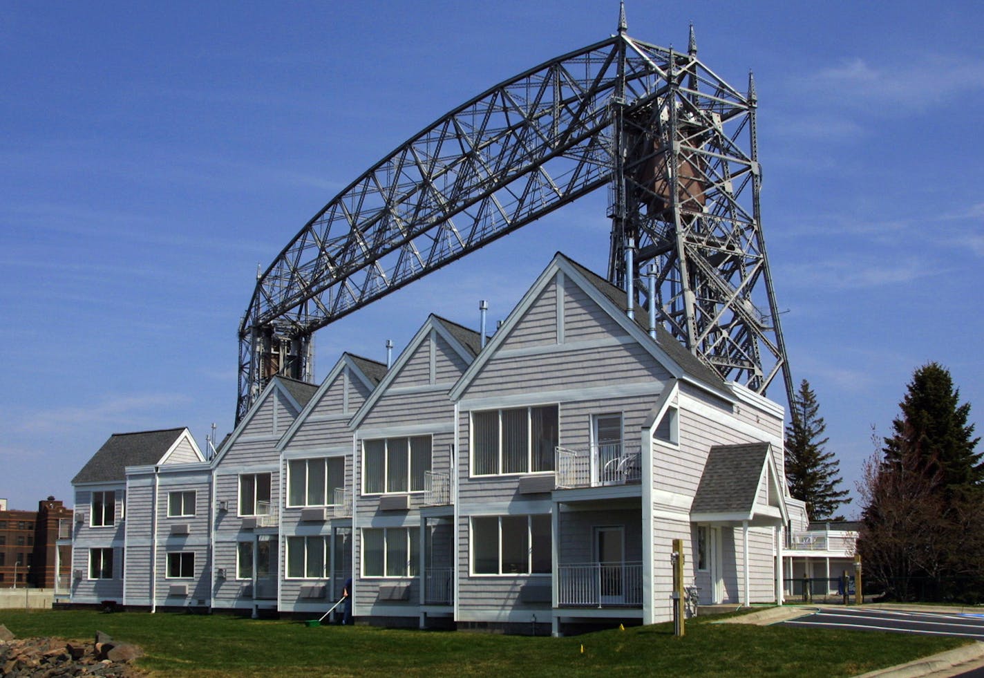 GENERAL INFORMATION: DULUTH, MN - WED - 5/22/2002 - Larry Oakes story on Aerial Lift Bridge operator at Duluth's Harbor Canal. Meet lift bridge supervisor at noon. IN THIS PHOTO: On the south side shore is the soon to open 30 unit "South Pier Inn" with accomodations ranging up to $259 a night. The bridge operators wonder aloud how long the "ambiance" factor will last after hearing bells, horns and loudspeaker announcements throughout the day and night.