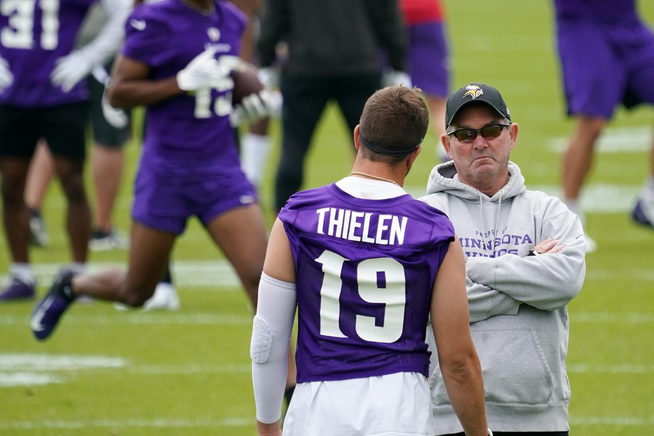 Minnesota Vikings wide receiver Adam Thielen (19) talked with head coach Mike Zimmer.