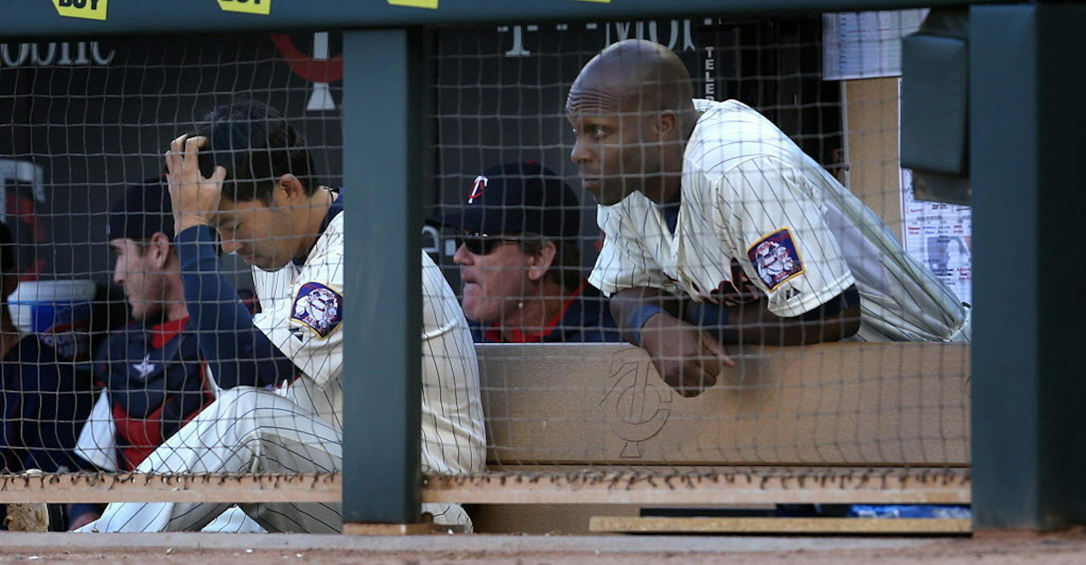 Catcher Kurt Suzuki, left, and outfielder Torii Hunter sat in the dugout as the ninth inning slipped away at Target Field.