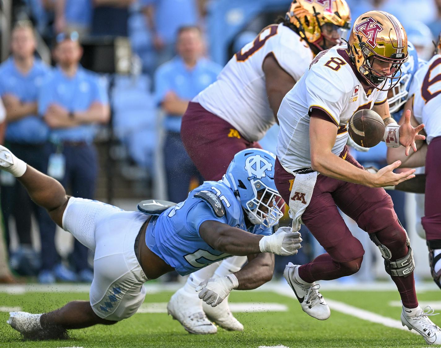 Minnesota quarterback Athan Kaliakmanis (8) bobbles the ball under pressure from North Carolina linebacker Kaimon Rucker (25) during the second half at Kenan Memorial Stadium on Saturday, Sept. 16, 2023, in Chapel Hill, North Carolina. (Grant Halverson/Getty Images/TNS)