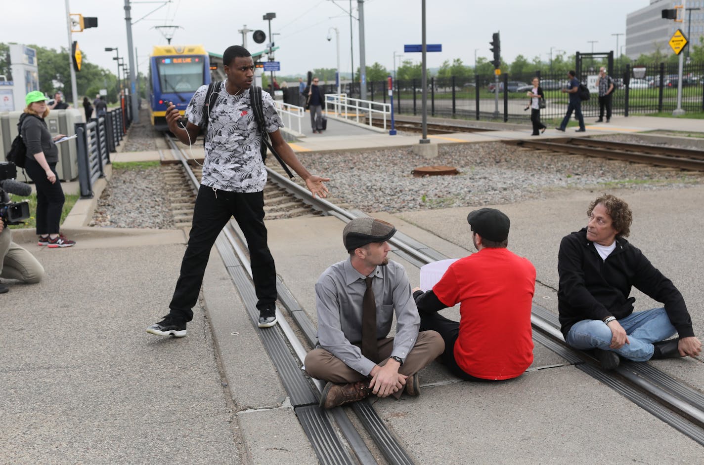 A frustrated commuter who had been on a light rail train asked demonstrators to move off the track so the train could proceed before law enforcement officials began arresting protestors who had shut down the light rail at the Fort Snelling light rail station by blocking the train tracks Tuesday, May 22, 2018, in Minneapolis, MN. The protest was in response to ICE raids on undocumented immigrants in the U.S.