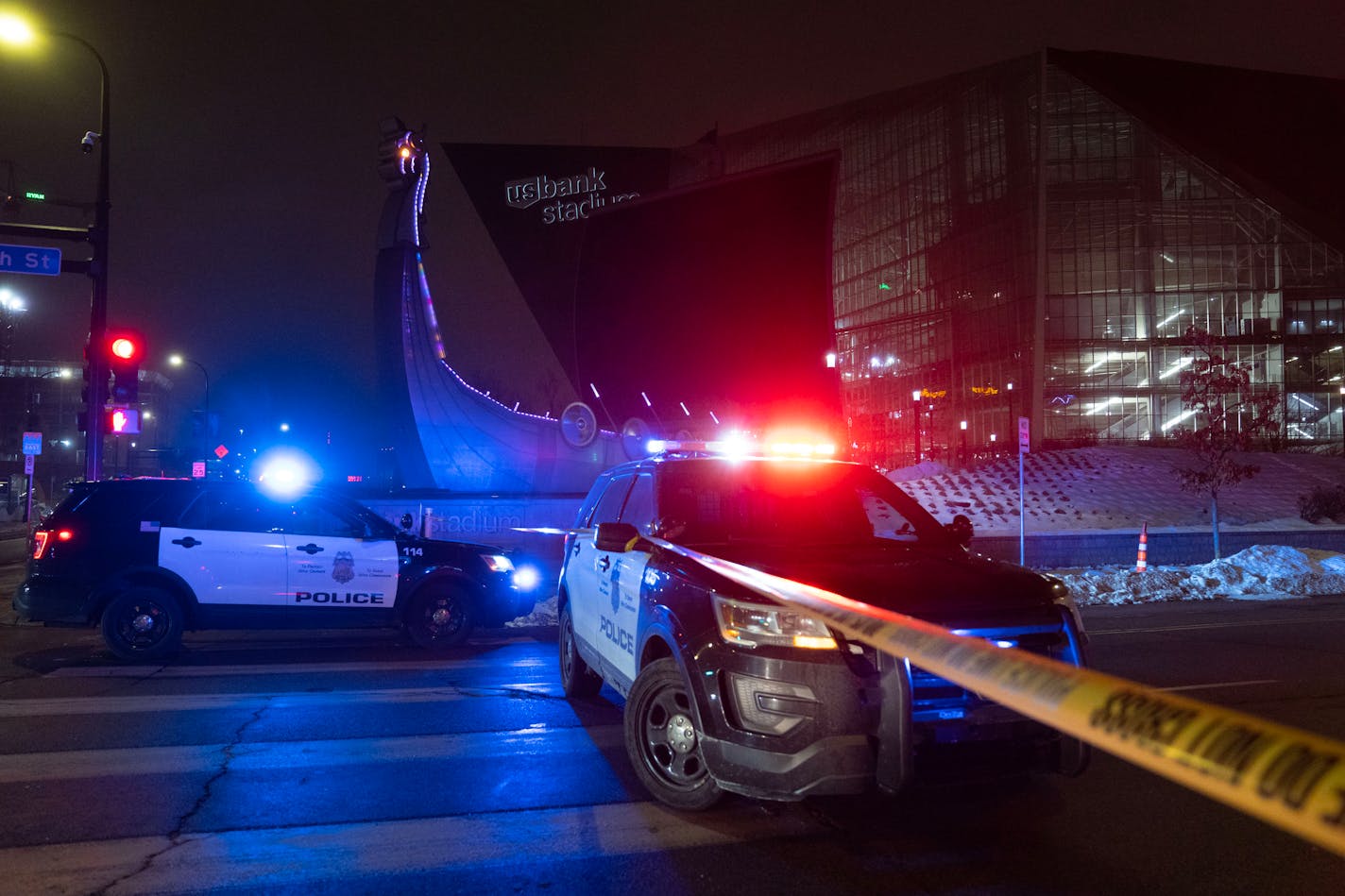 Police vehicles block the road near the scene of a fatal shooting on Friday, Dec. 30, 2022 near U.S. Bank Stadium.