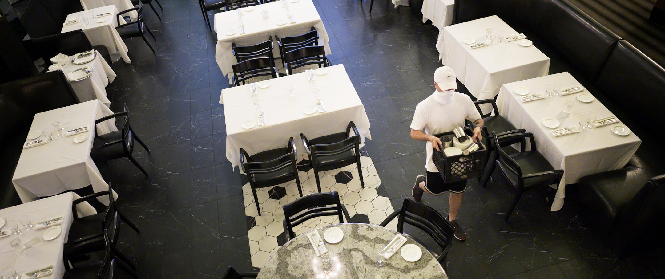 Eli Fhima, son of restauranteur David Fhima and operations manager, works on clearing the kitchen of all items at the restaurant in Minneapolis on Wednesday, May 20, 2020, before a deep cleaning. (Aaron Lavinsky/Star Tribune via AP)