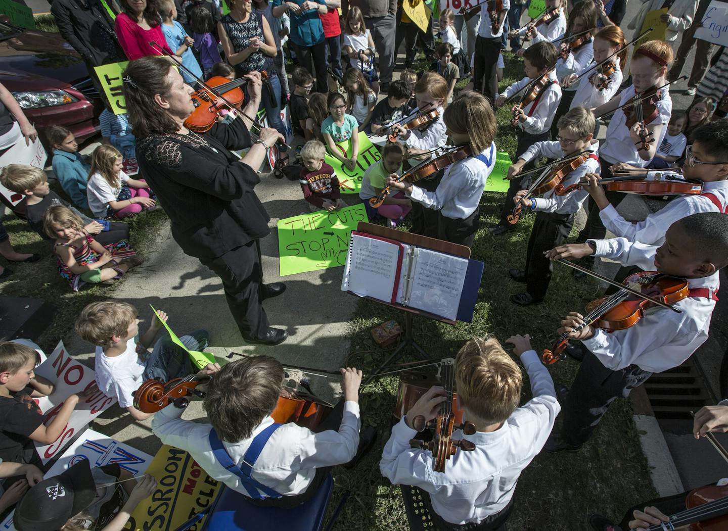 Members of the LNFI ( L'Etoile du Nord French Immersion School) Fabulous Fiddlers music group, joined the protest with a few songs outside the St. Paul School District Offices Tuesday afternoon. ] Parents and advocates staged a rally Tuesday to protest cuts to music, art and other programs in the St. Paul school district. The school board must resolve a $15.1 million budget shortfall for 2016-17 and are exploring a cost-saving maneuver that would limit electives in the elementary and middle scho