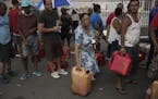 People line up to buy gas at a station in Humacao, Puerto Rico, several days after Hurricane Maria caused widespread damage, Sept. 24, 2017. Facing mo