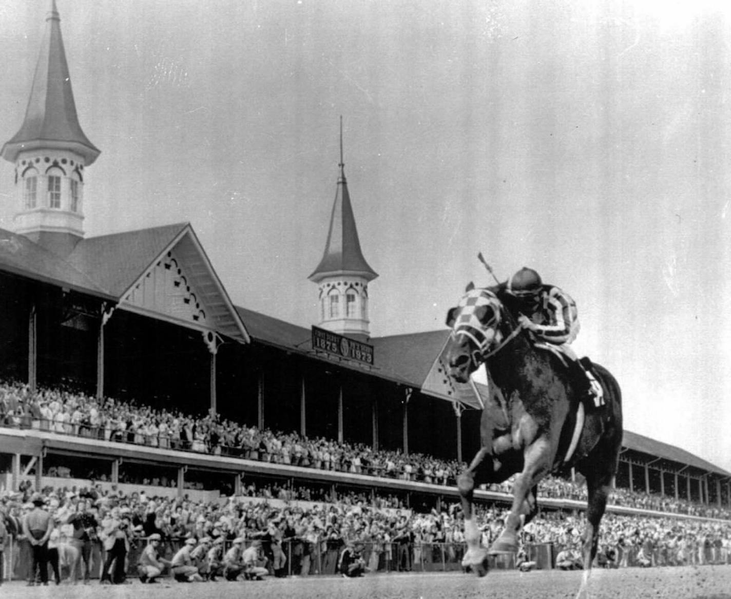 Secretariat, with Jockey Ron Turcotte up, crosses the finish line alone to win the Kentucky Derby in 1973.