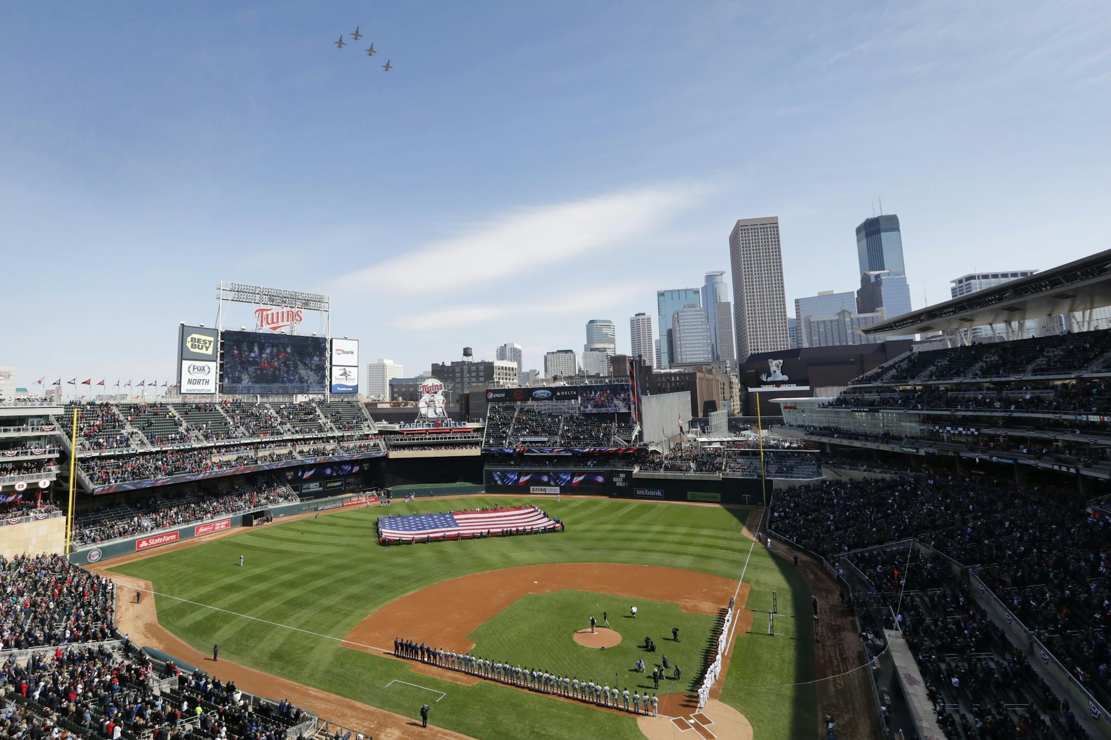 Four T-38s from the United States Air Force flyover Target Field during the National Anthem before the game.