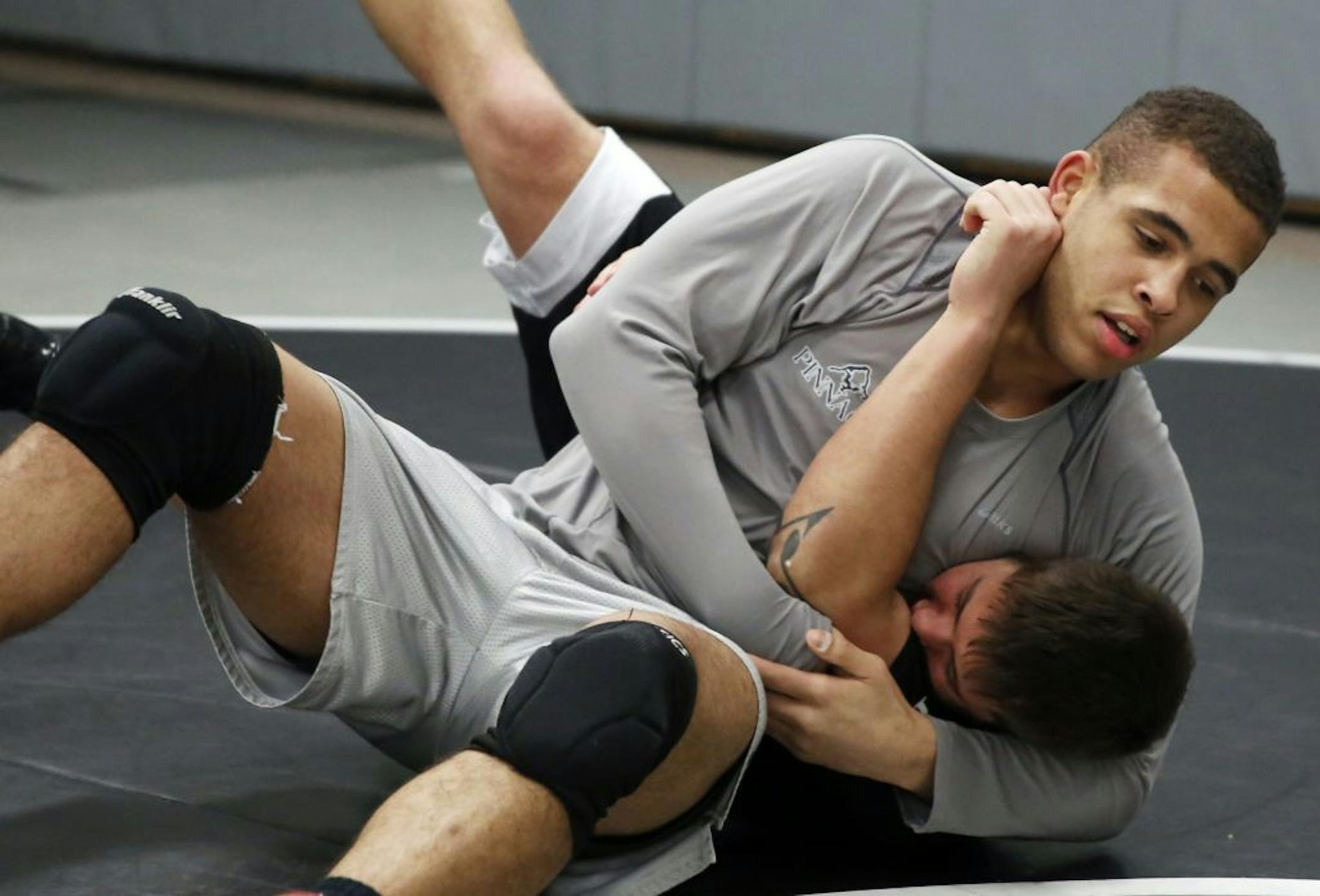 Roseville's Trae Story (top), warming up with assistant coach Peter Salas, is 39-0 this year and ranked No. 3 at 195 pounds.