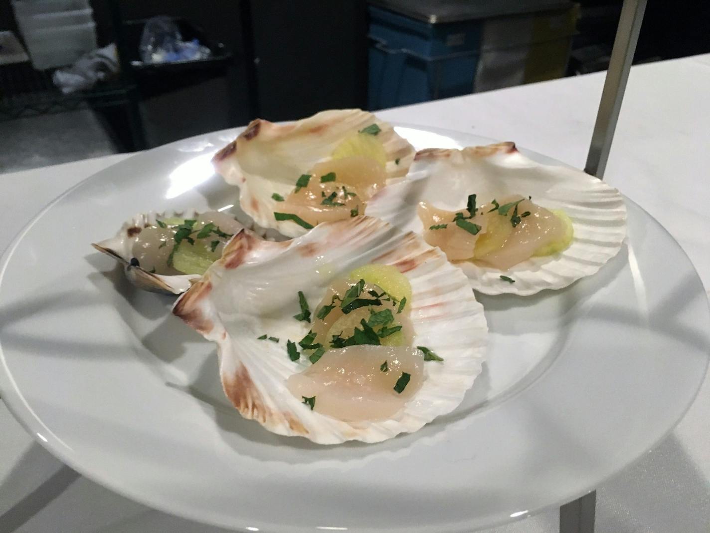 Scallops are served in seashells at Travail's Homage pop-up.