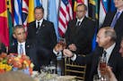 In this Monday, Sept. 28, 2015, photo, provided by the United Nations, U.S. President Barack Obama, left, and Russia's President Vladimir Putin toast 