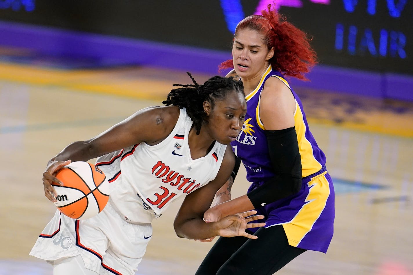 Washington Mystics center Tina Charles (31) is defended by Los Angeles Sparks center Amanda Zahui B during the first half of a WNBA basketball game Thursday, June 24, 2021, in Los Angeles.(AP Photo/Marcio Jose Sanchez)