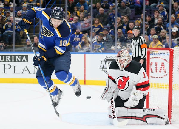The St. Louis Blues' Brayden Schenn hops clear of a teammate's shot against New Jersey Devils goaltender Keith Kinkaid in the first period on Tuesday,