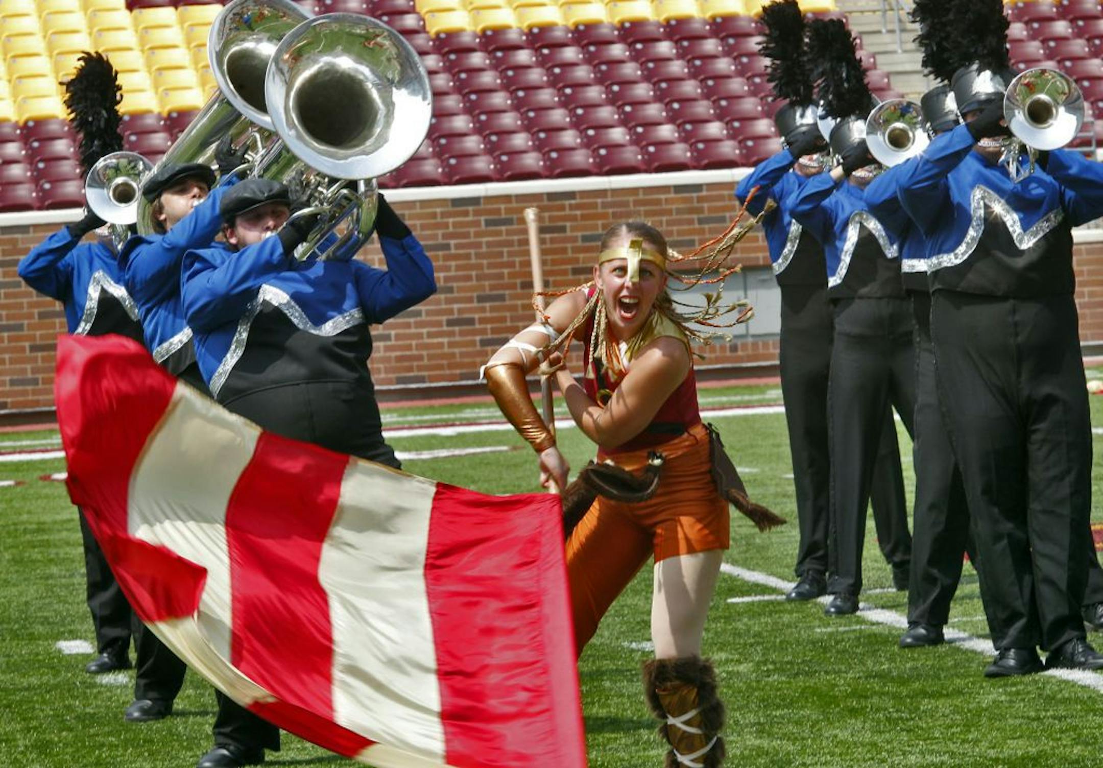 Drum Corp International - Minnesota competition took place Saturday at TCF stadium on UM campus. Local corp group Minnesota Brass competed in the All Ages category Saturday, July 16, 2011. Minnesota Brass is a 130-member strong group from St. Paul. They presented a Viking oriented program. Brianna Koester paraded a flag as the brass played in the background.