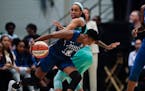 Minnesota Lynx's Danielle Robinson, front, drives past New York Liberty's Asia Durr during the first half of a WNBA basketball game Wednesday, June 12